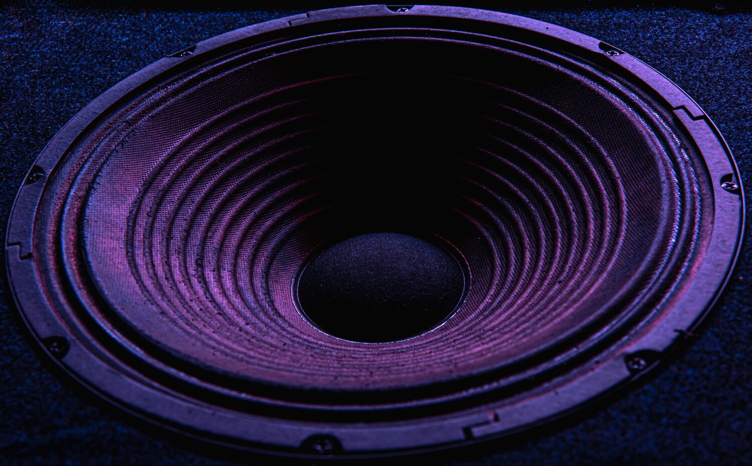 Close up speaker membrane black background with colored lighting 169016 14352