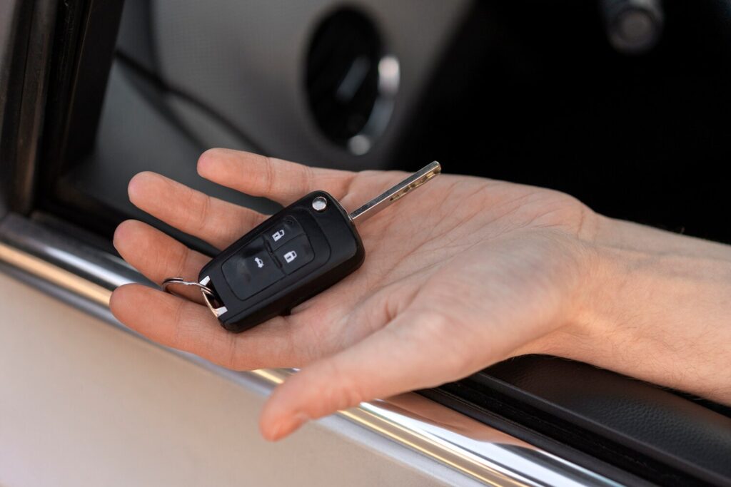 High angle hand holding car key 23 2150321006